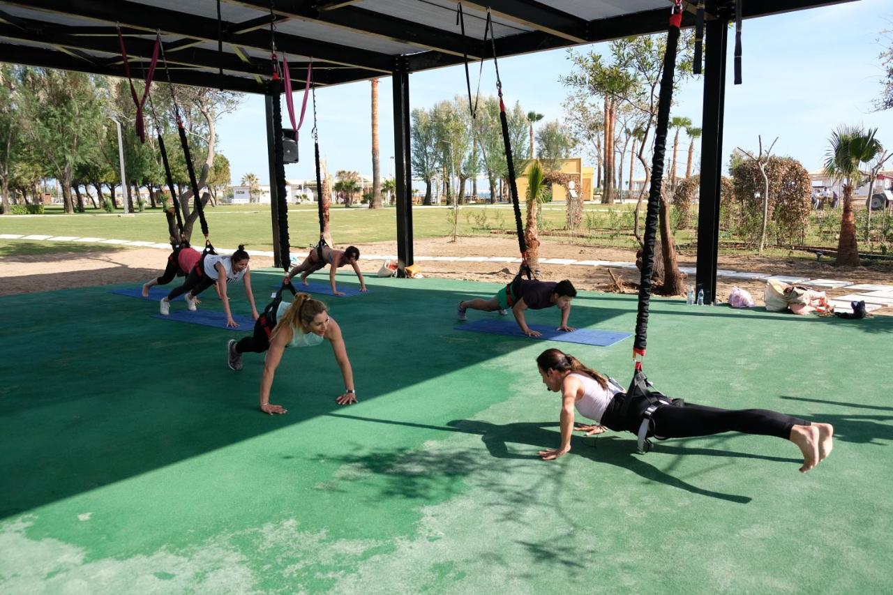 Lara Barut Collection Hotel Antalya Exterior foto A group of women doing yoga at the park